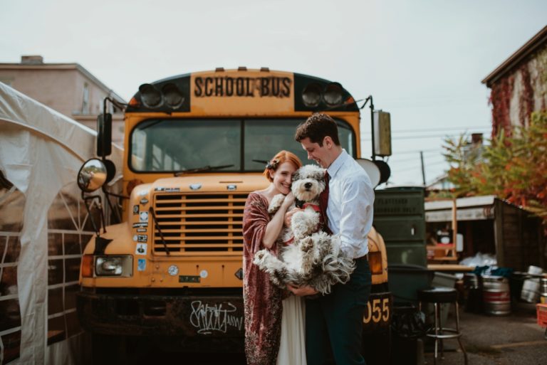 offbeat bride and groom with dog at spirit pittsburgh in front of schoolbus